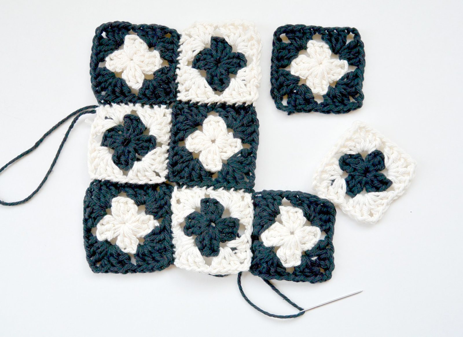 Stitching 9 crocheted granny squares together to form a potholder