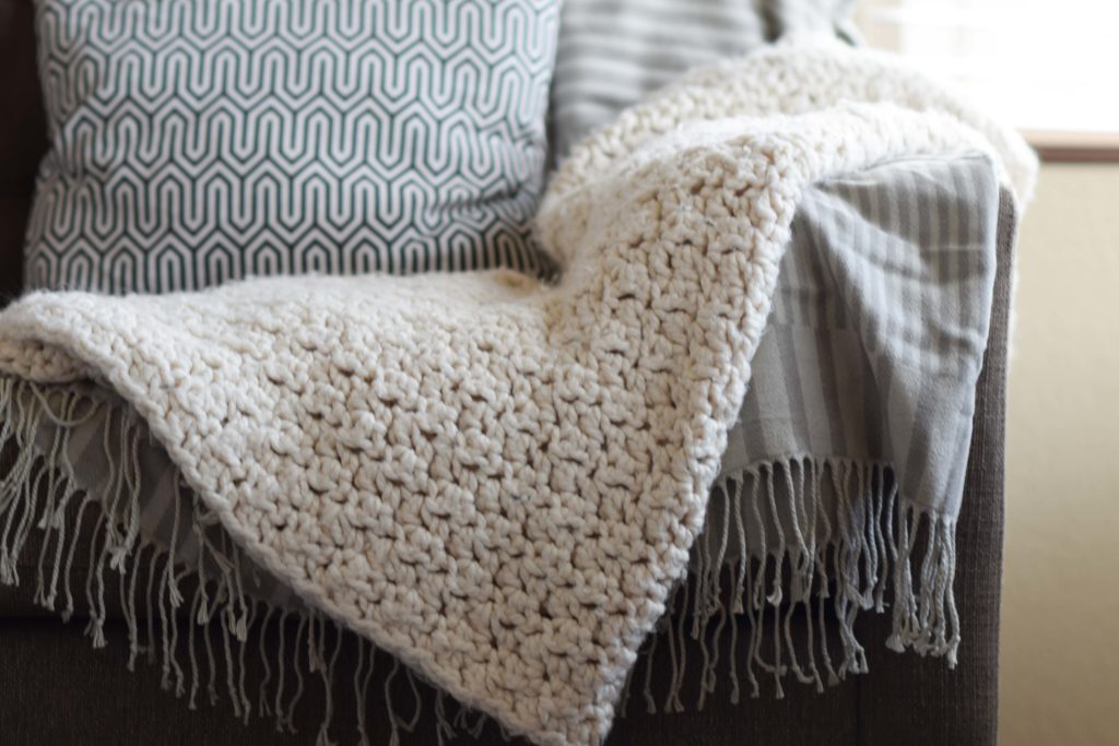 Chunky crochet blanket throw on a couch