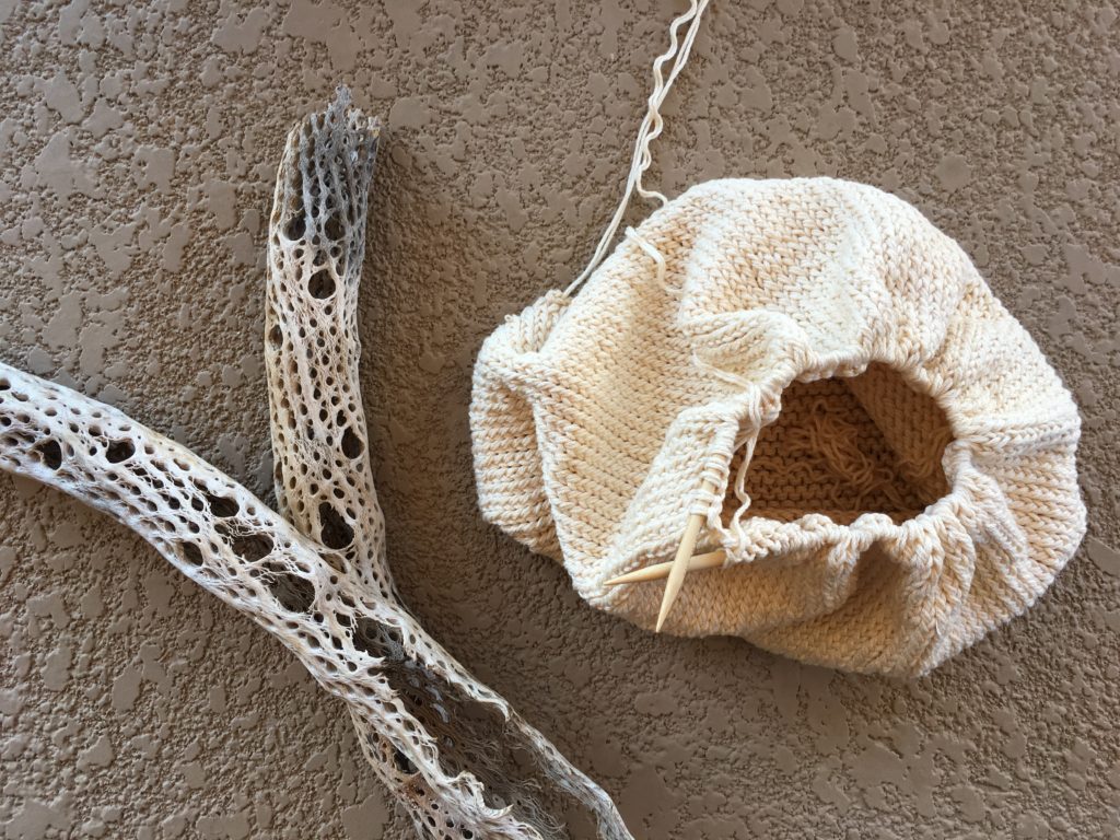 two knotting needles shown piecing together a straw backpack 